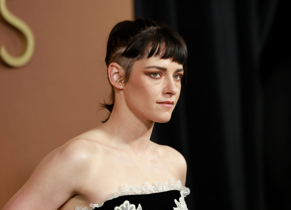 Kristen Stewart appears at the Governors Awards in a strapless dress. Her hair is shaved on the sides.